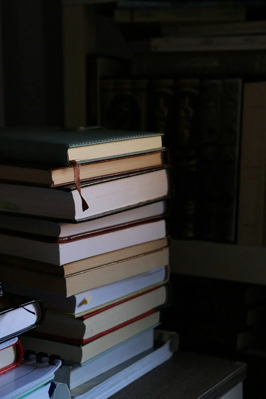 A stack of books in low light.